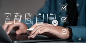 Businessman using laptop with document online for approve quality assurance and ERP management, Quality management with assurance, Quality control and improvement.
