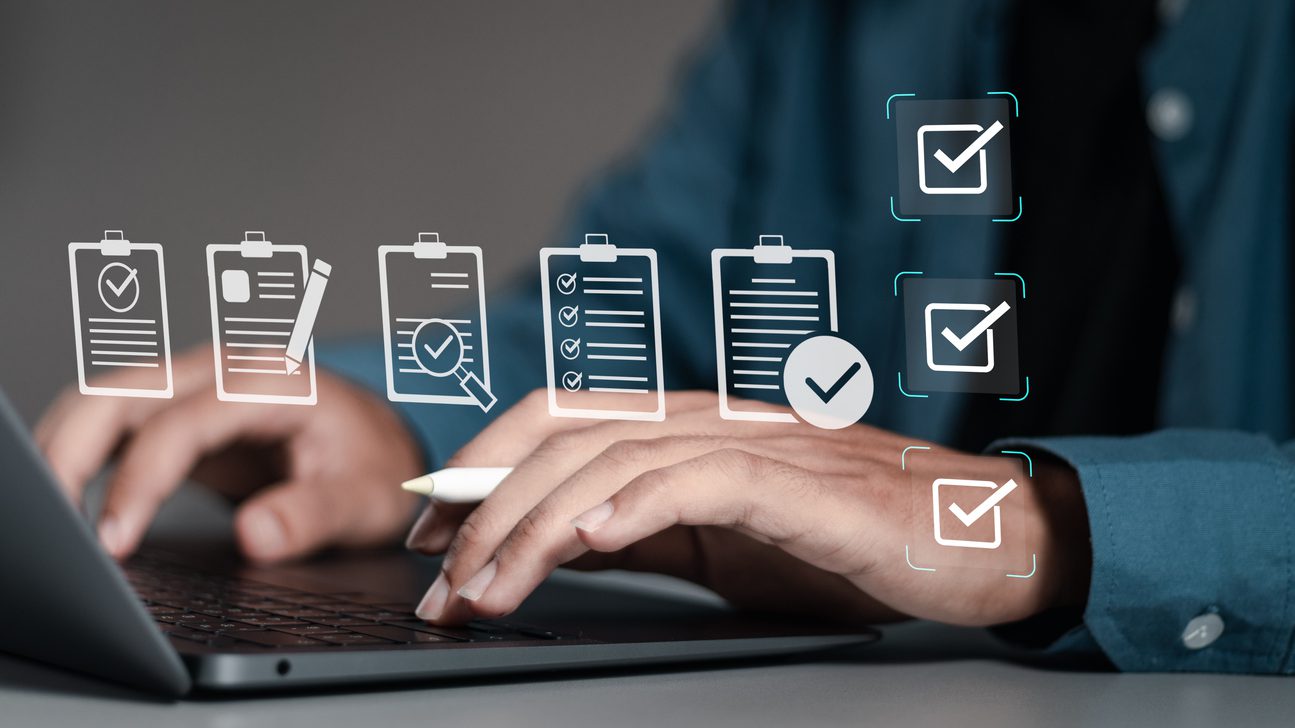 Businessman using laptop with document online for approve quality assurance and ERP management, Quality management with assurance, Quality control and improvement.