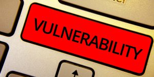 Text sign showing Vulnerability. Conceptual photo Information susceptibility systems bug exploitation attacker Keyboard brown keys yellow laptop idea create computer keypad laptop