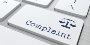 White Button with Complaint on Computer Keyboard. Business Concept.