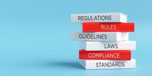 Books forming a stack with words regulations, rules, guidelines, laws, compliance and standards, compliance concept. 3D render.