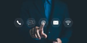 Customer Service Call Center, Contact US, Support Hotline, Businessman touches virtual communication icons including phone, chat, email, and Wi-Fi, highlighting modern digital connectivity in business