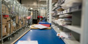 Letters on a sorting frame, table and shelves in a mail delivery sorting centre. Postal service, post office inside