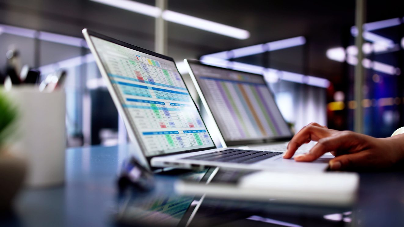 Calculating electronic medical accounts and codes in a black office using a spreadsheet on a computer screen.