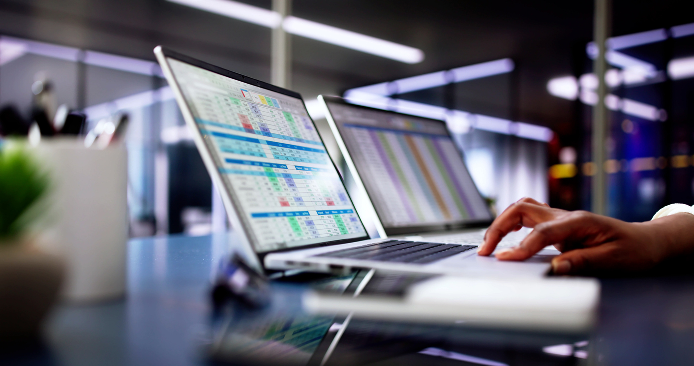 Calculating electronic medical accounts and codes in a black office using a spreadsheet on a computer screen.