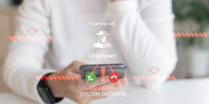 Smartphone shows system warning for incoming unknown call.