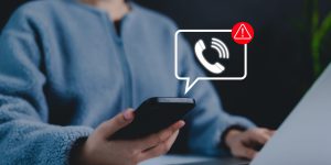 A person holding a smartphone with a digital scam warning notification