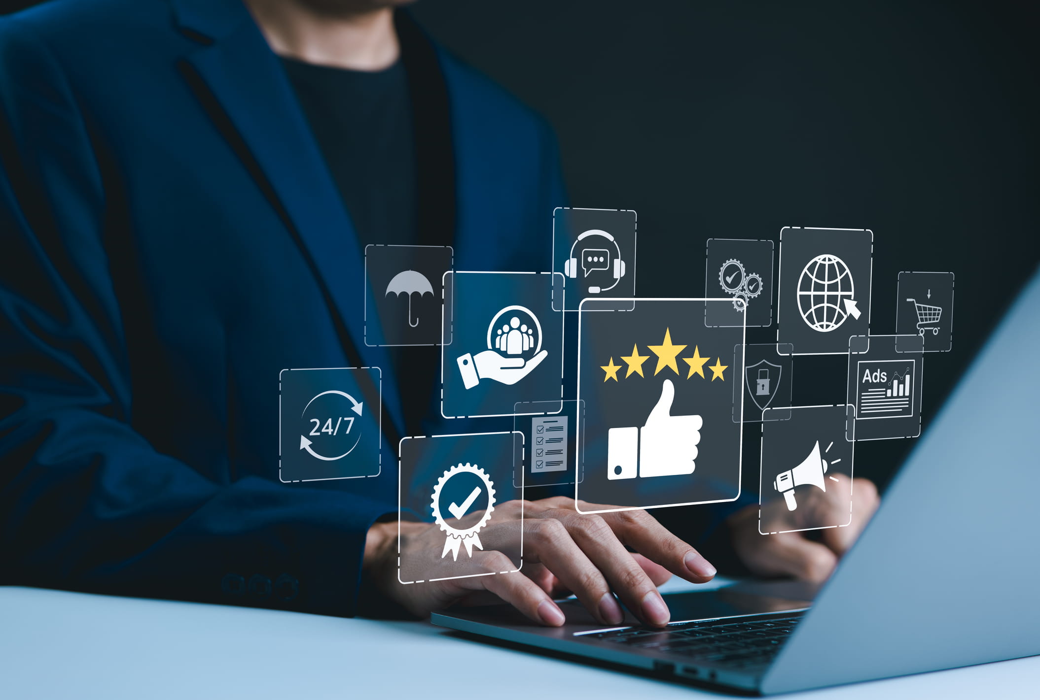 Businessman types on a laptop with icons representing service excellence