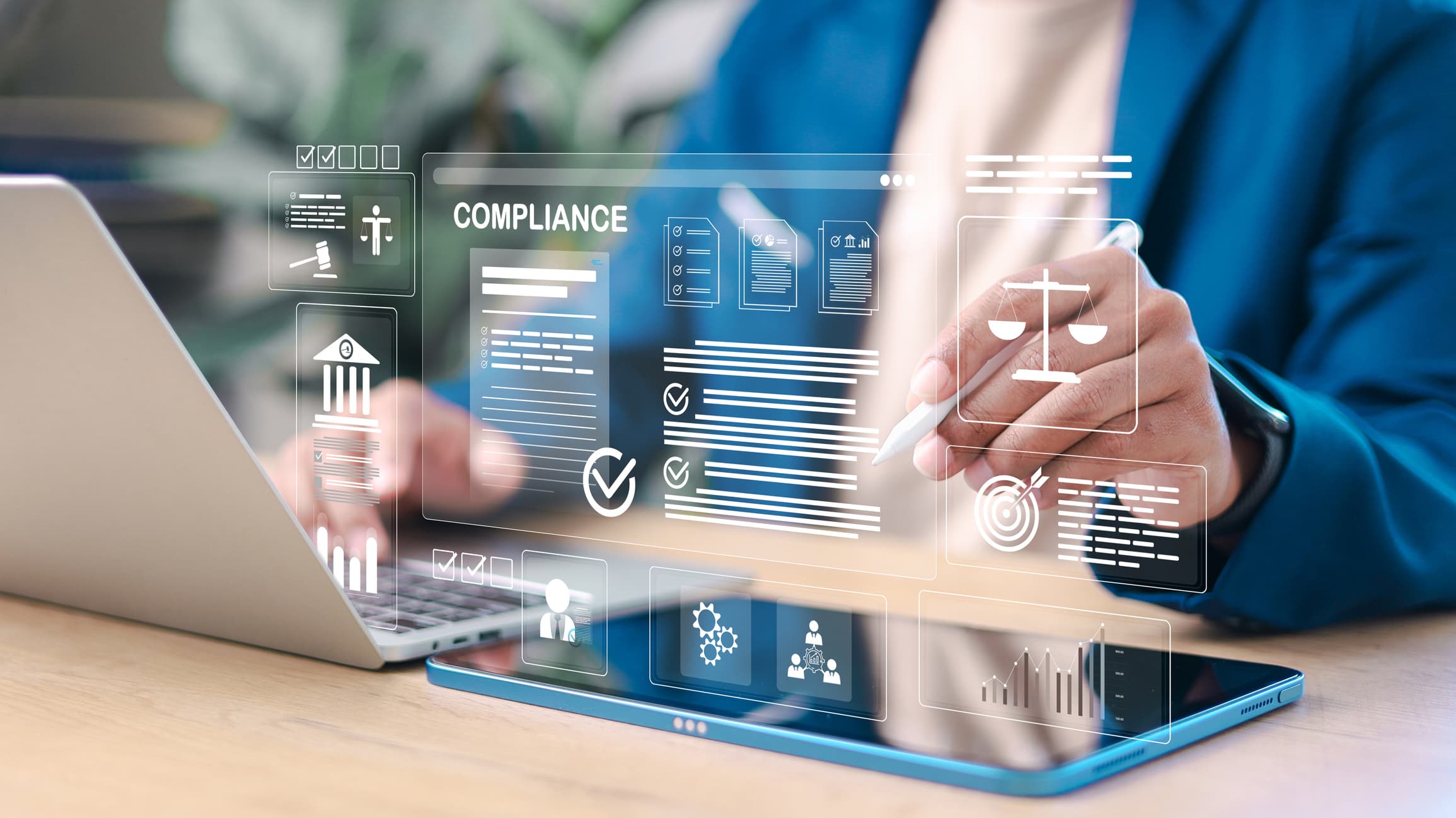 Business professional reviewing digital compliance documents on laptop and tablet