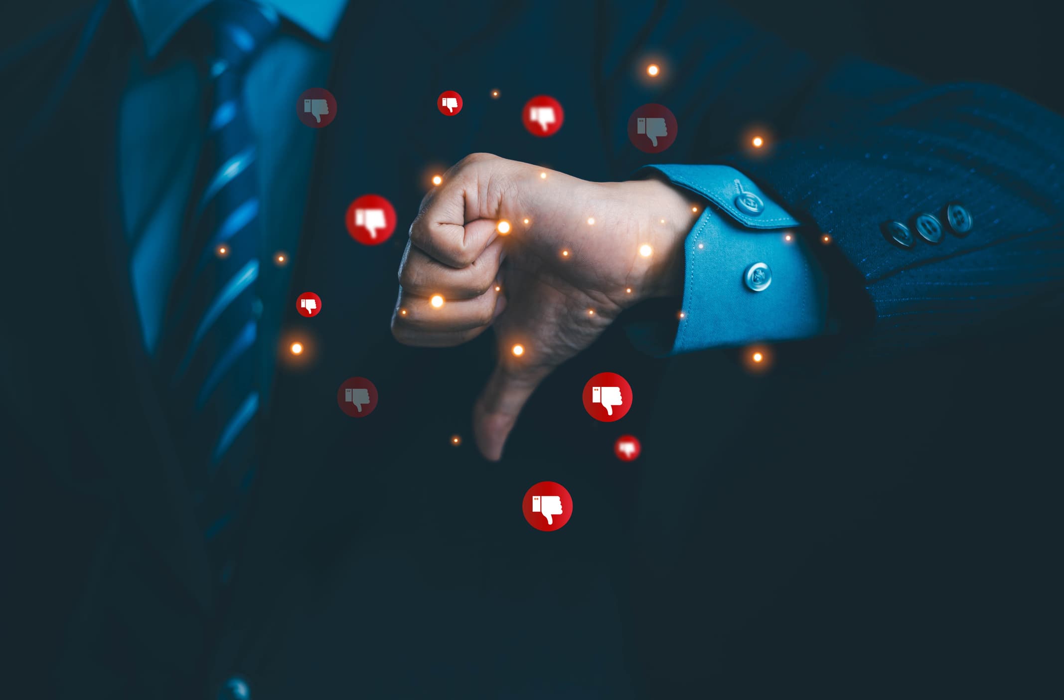 Businessman giving a thumbs down with negative feedback icons