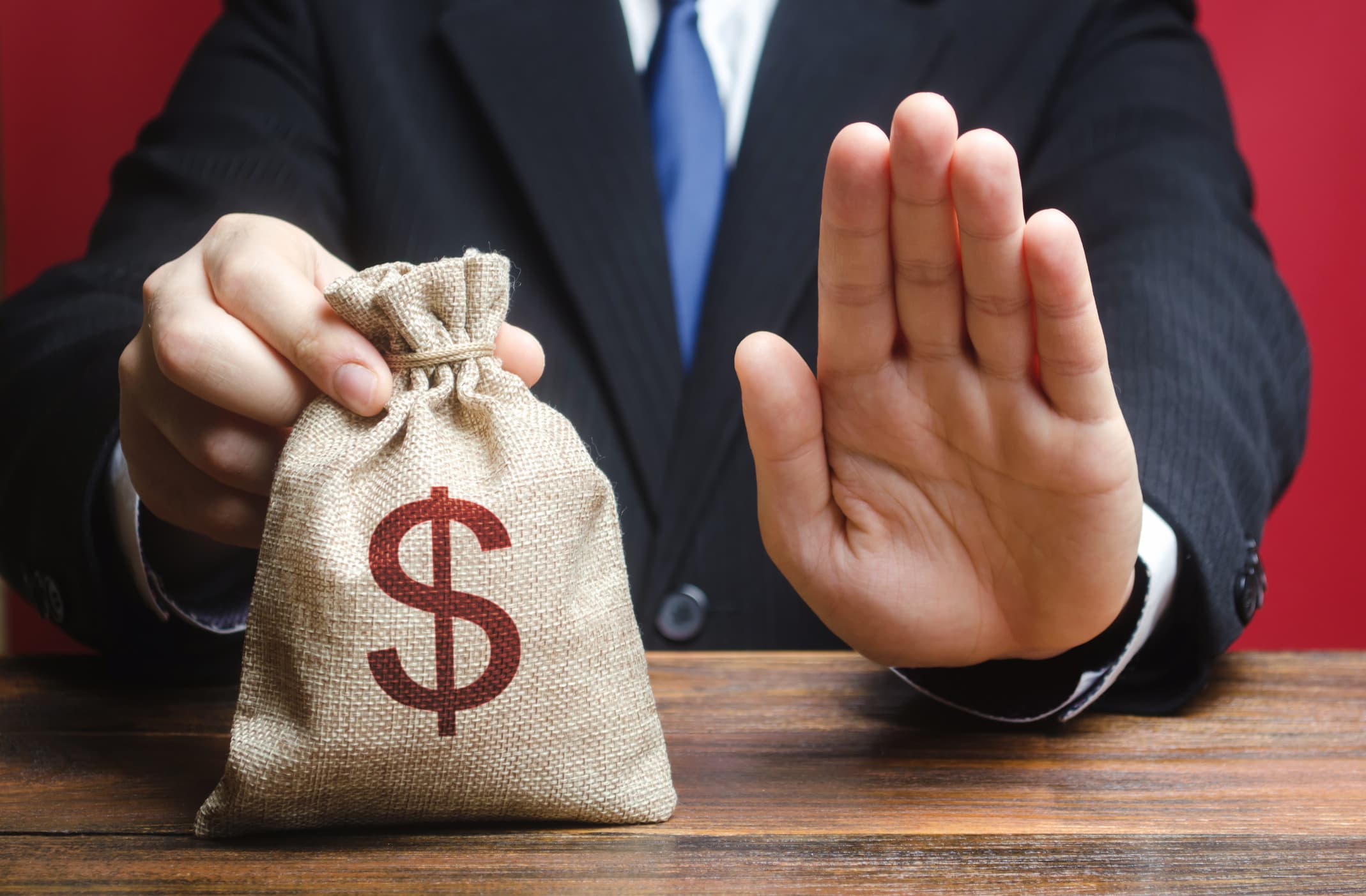 Businessman refuses to give a money bag