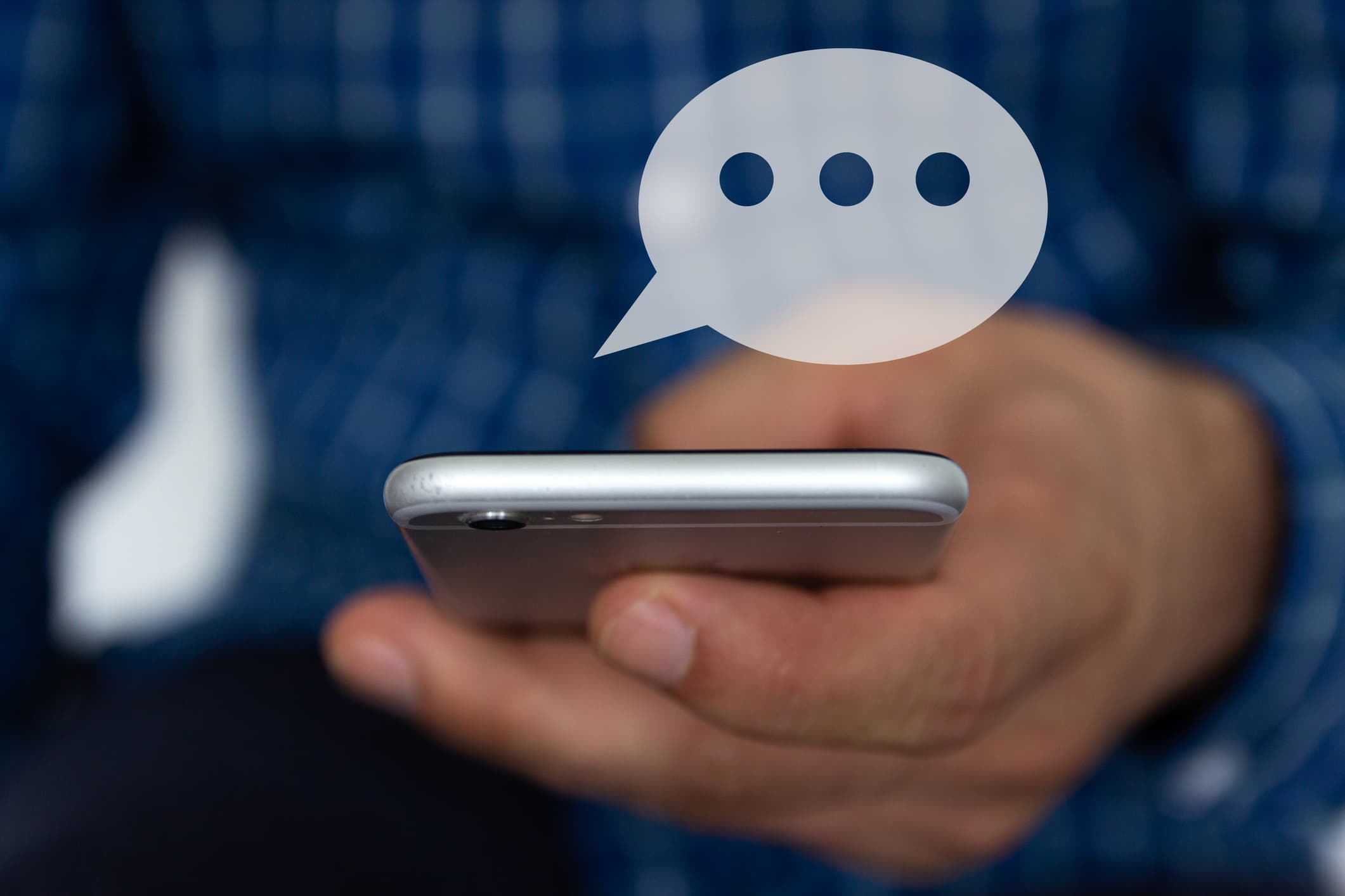 Hand of man typing text on mobile smartphone
