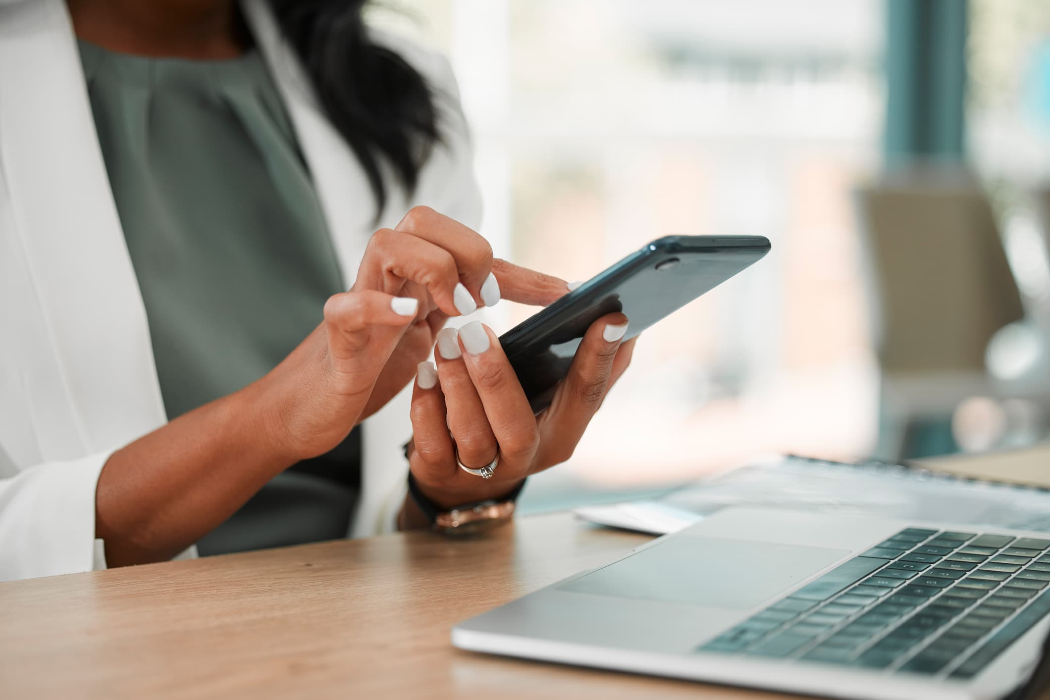 Phone, office and business woman networking on social media, the internet or a mobile app